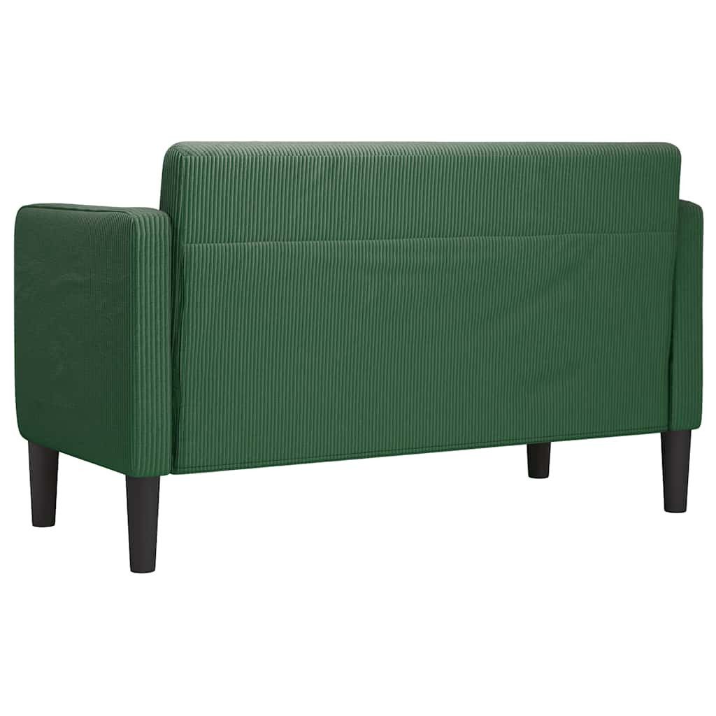 Cord Sofa in Dunkelgrün im Wohnraum mit Pflanze