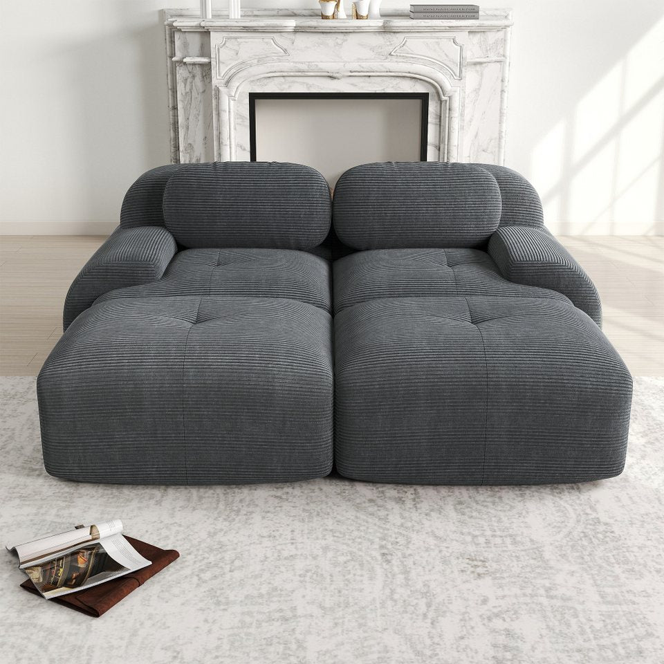 Graues Cord Sofa mit Chaiselongue von vorn